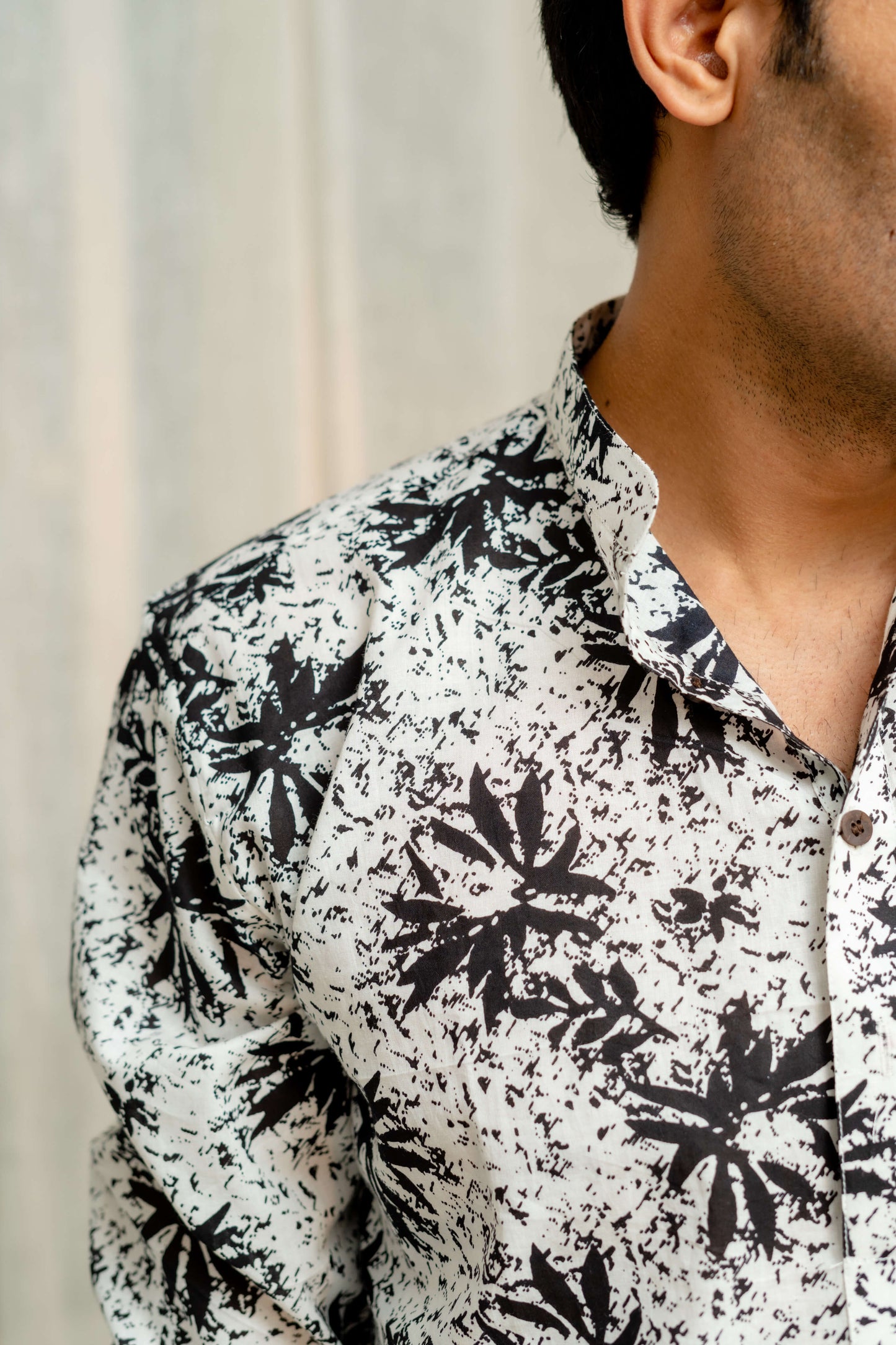 Close-up look of men's White long kurta with floral print