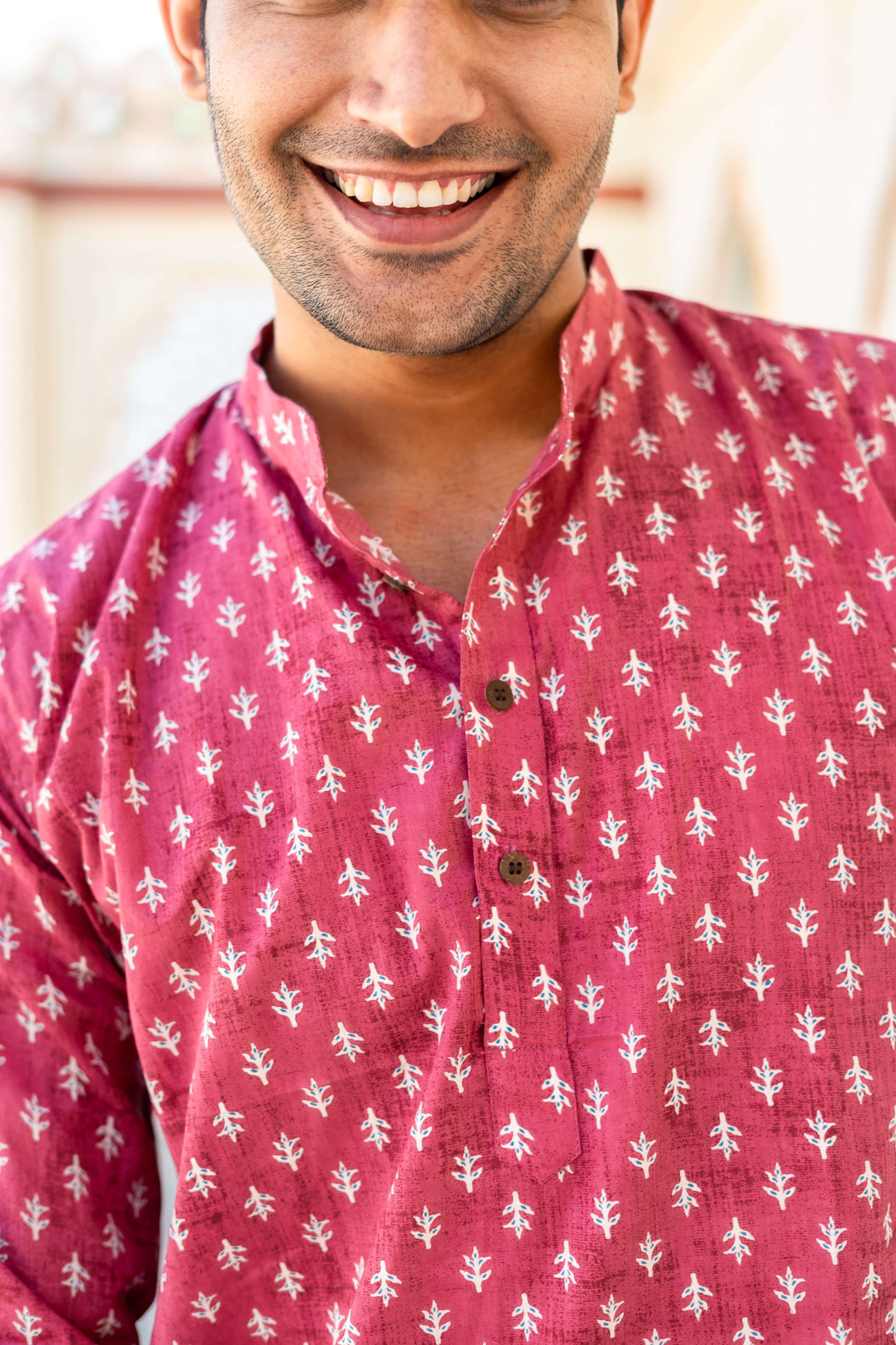 Close-up view of An Indian man wearing pink color short kurta