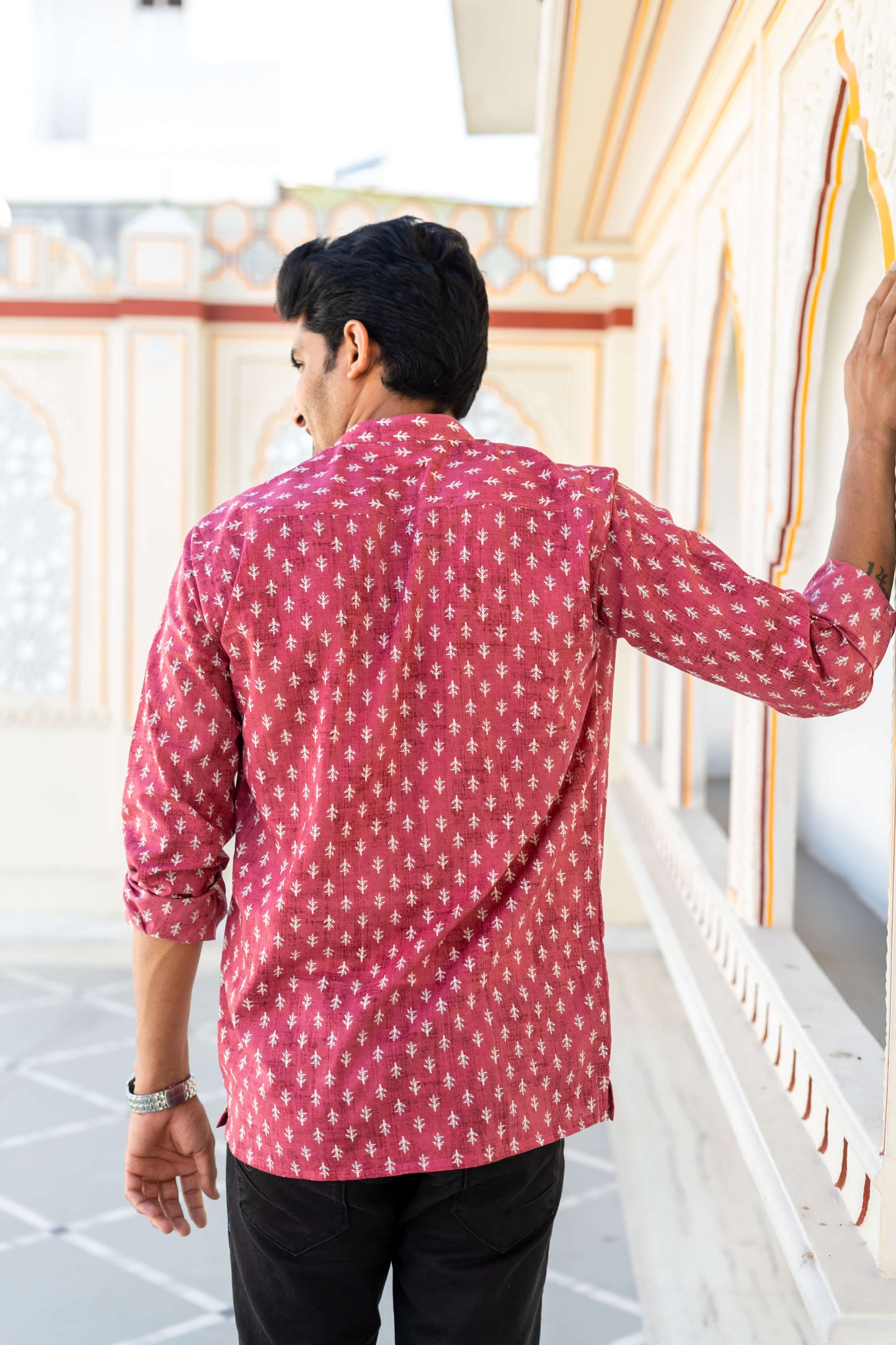 Backside view of An Indian man wearing a pink short kurta for men