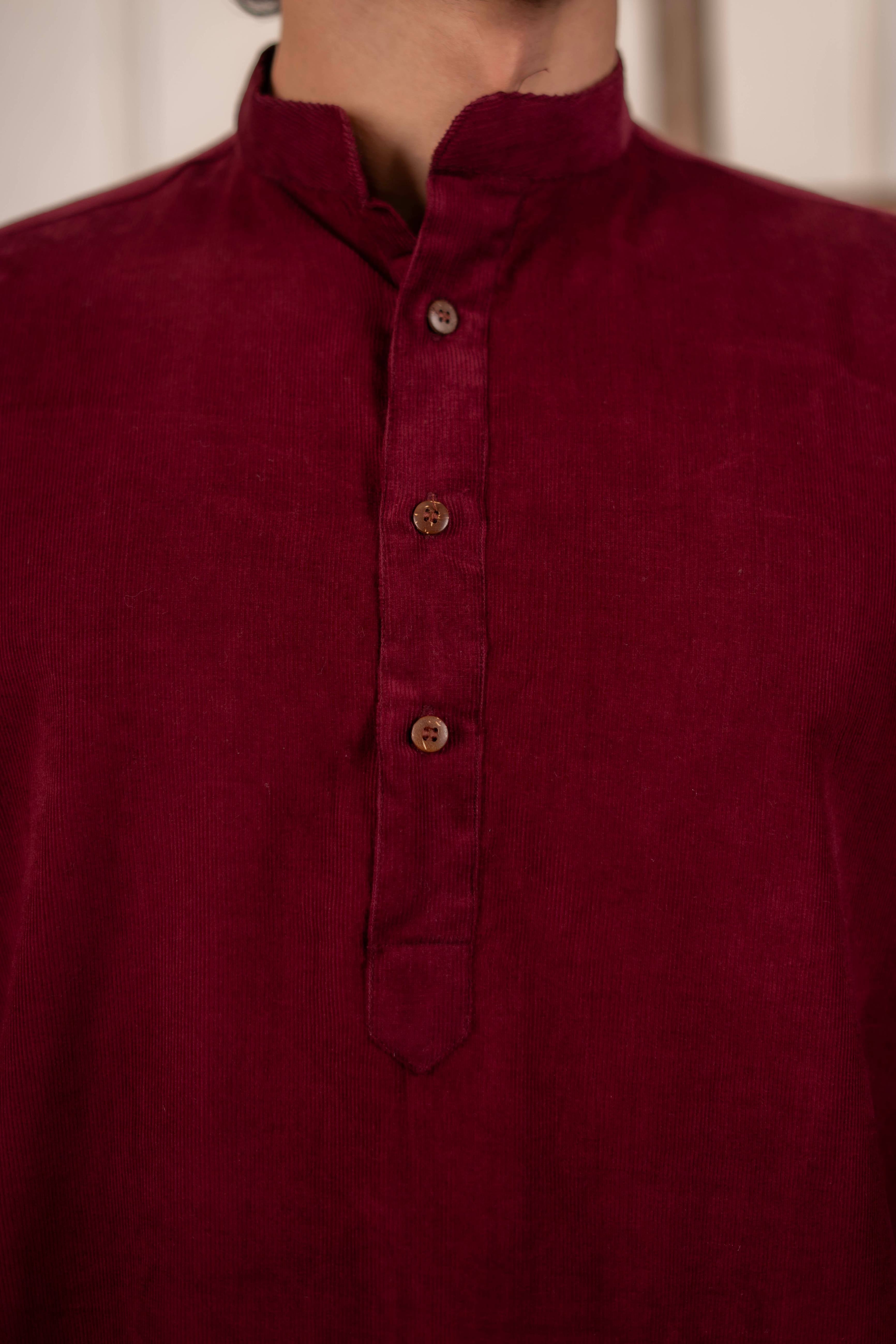 Maroon shirt with button details on a neutral background