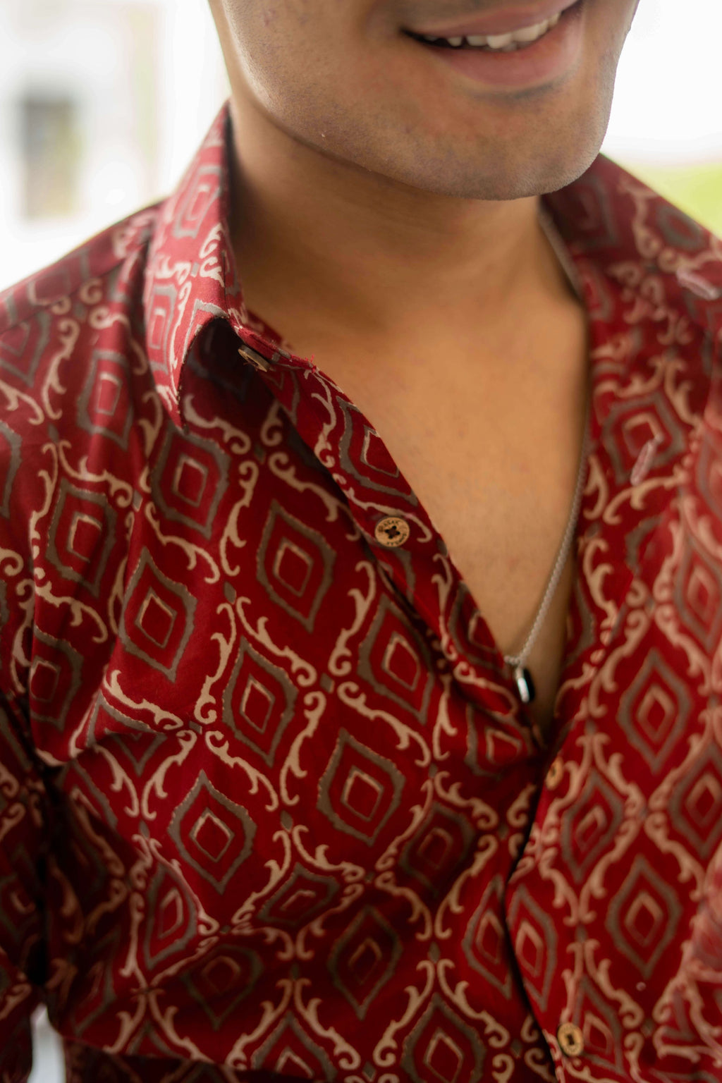 closeup view of red shirt with diamond print. 