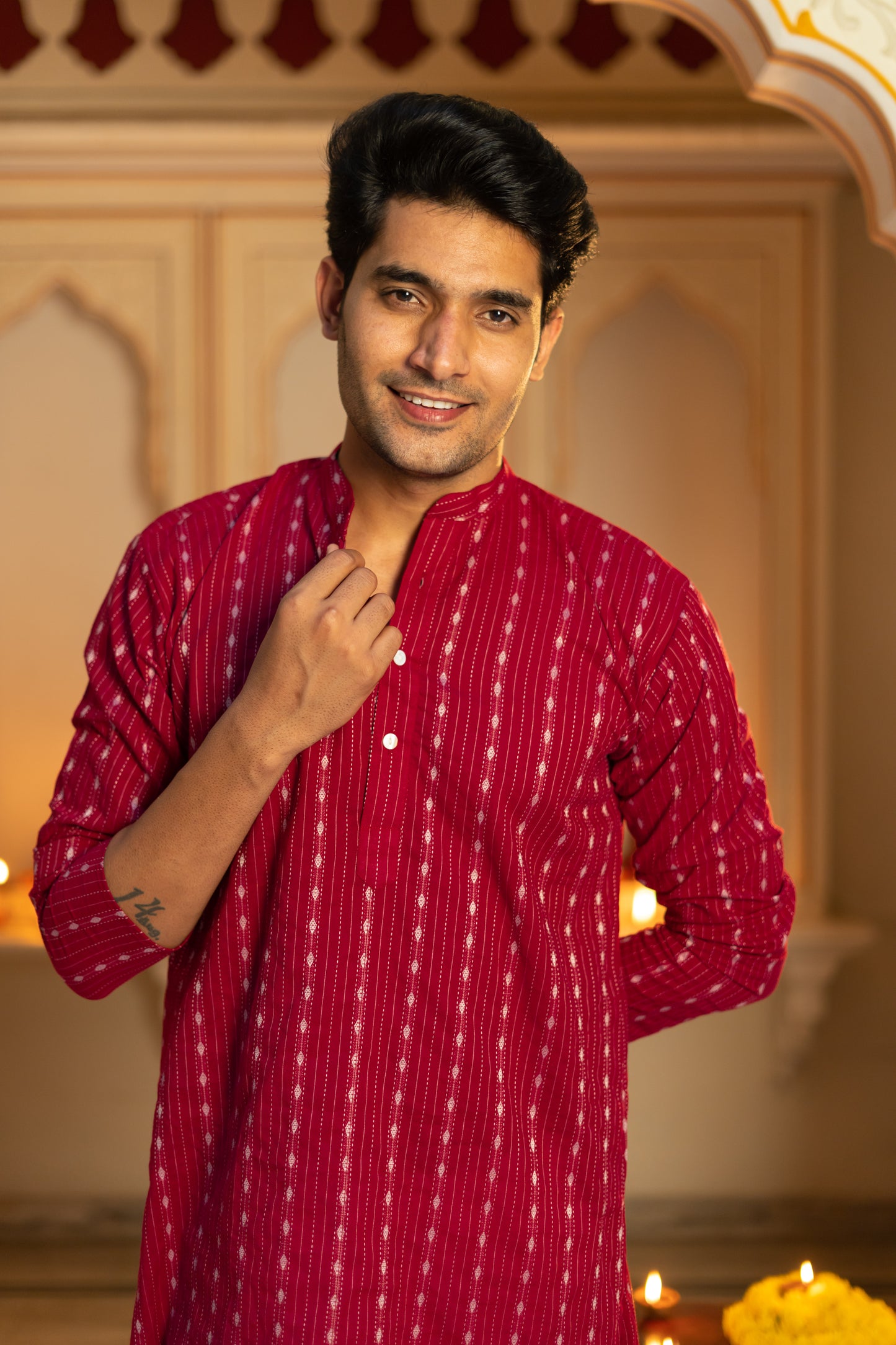 Indian man wearing maroon long kurta 