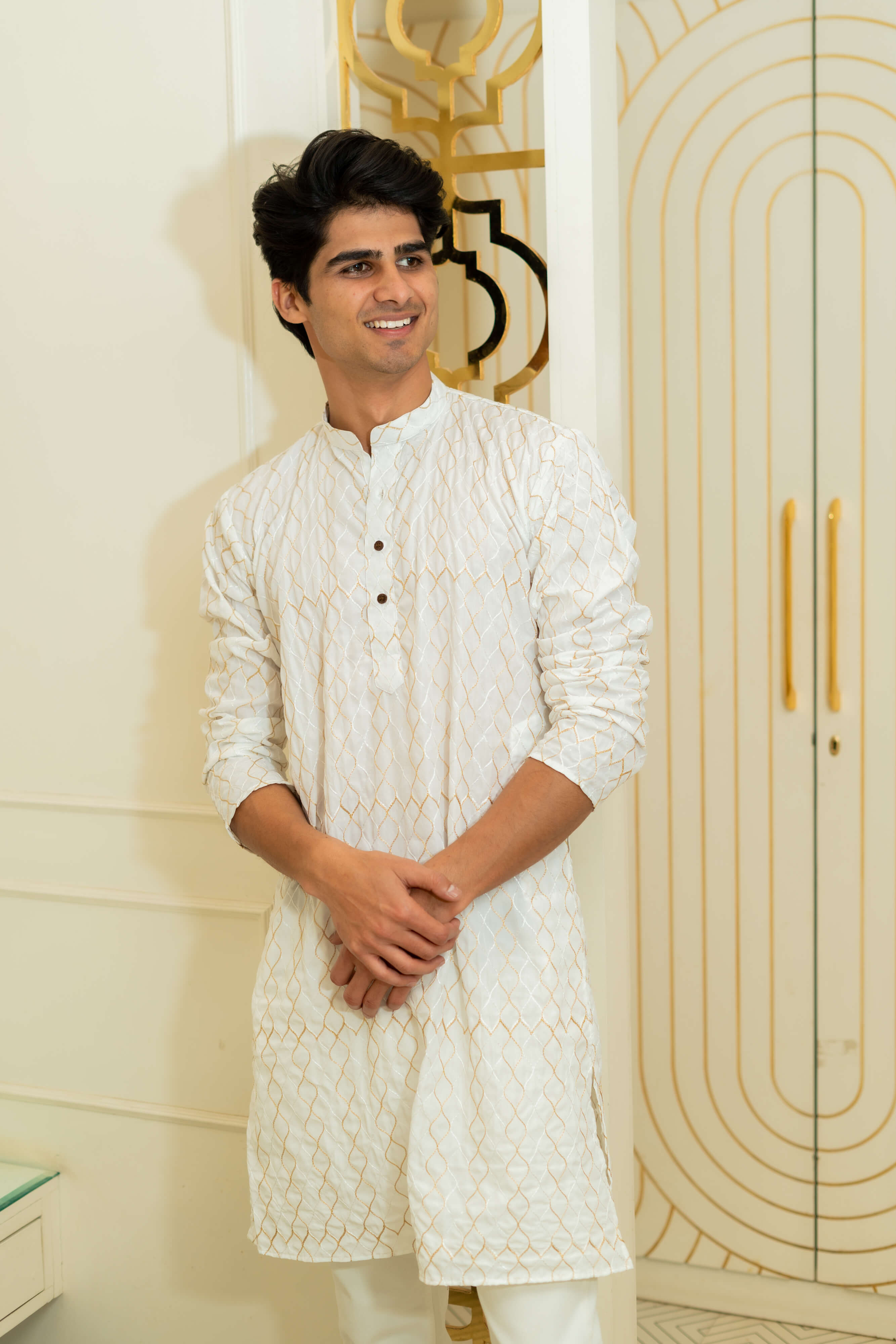 White long kurta with zari work worn by an Indian man
