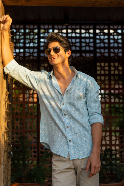 A White Kanta Work Shirt with a Blue Tribal Print Worn by an Indian Man. 