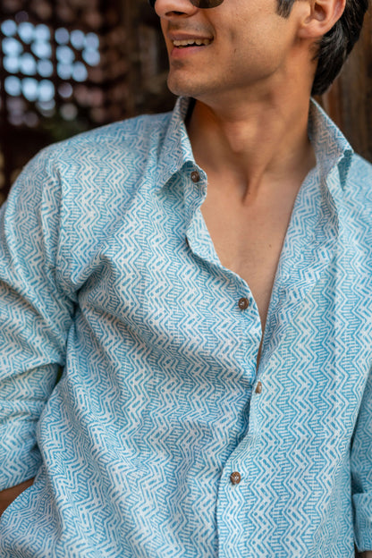 close up view of white kanta work shirt with blue tribal print. 