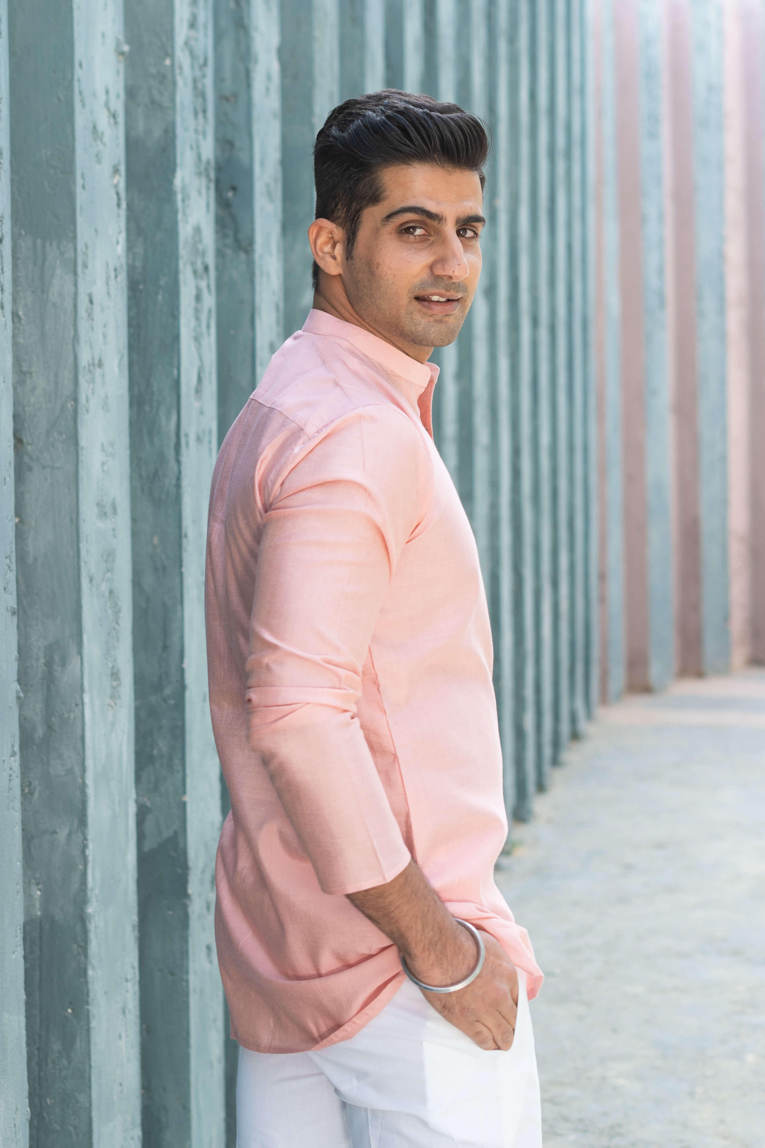 an Indian men wearing a pink color short kurta