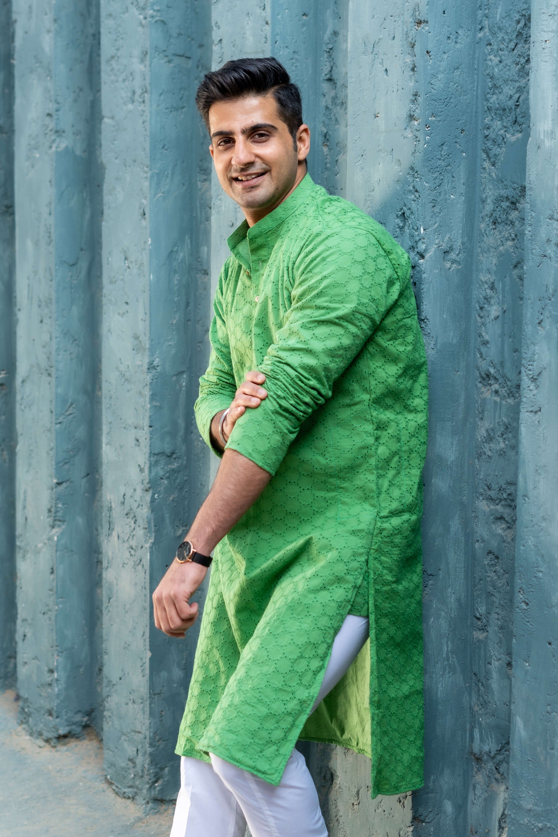 An indian man wearing green chikan kari long kurta