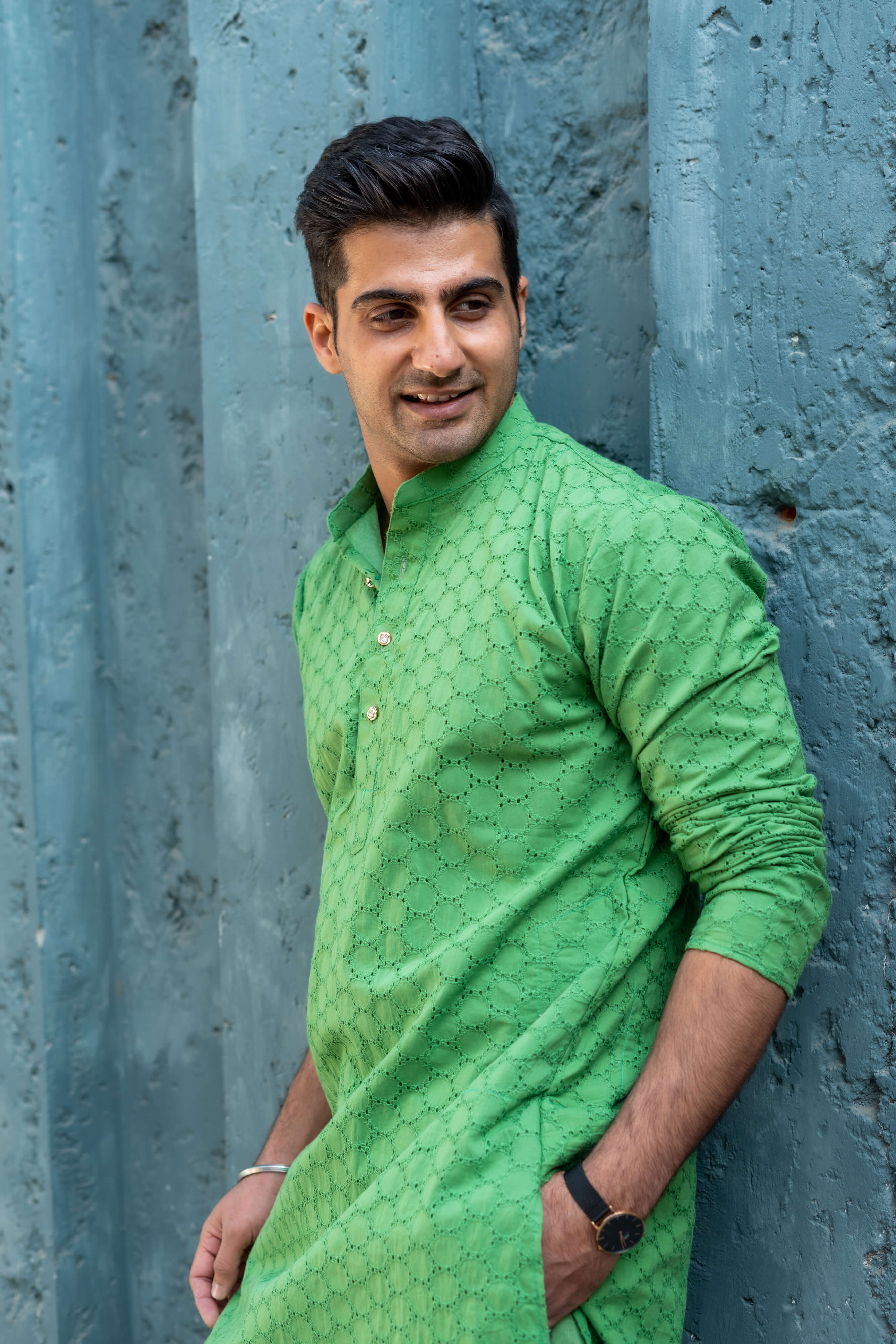 an Indian man wearing green chikan kari kurta for men with a beautiful smile on his face. 