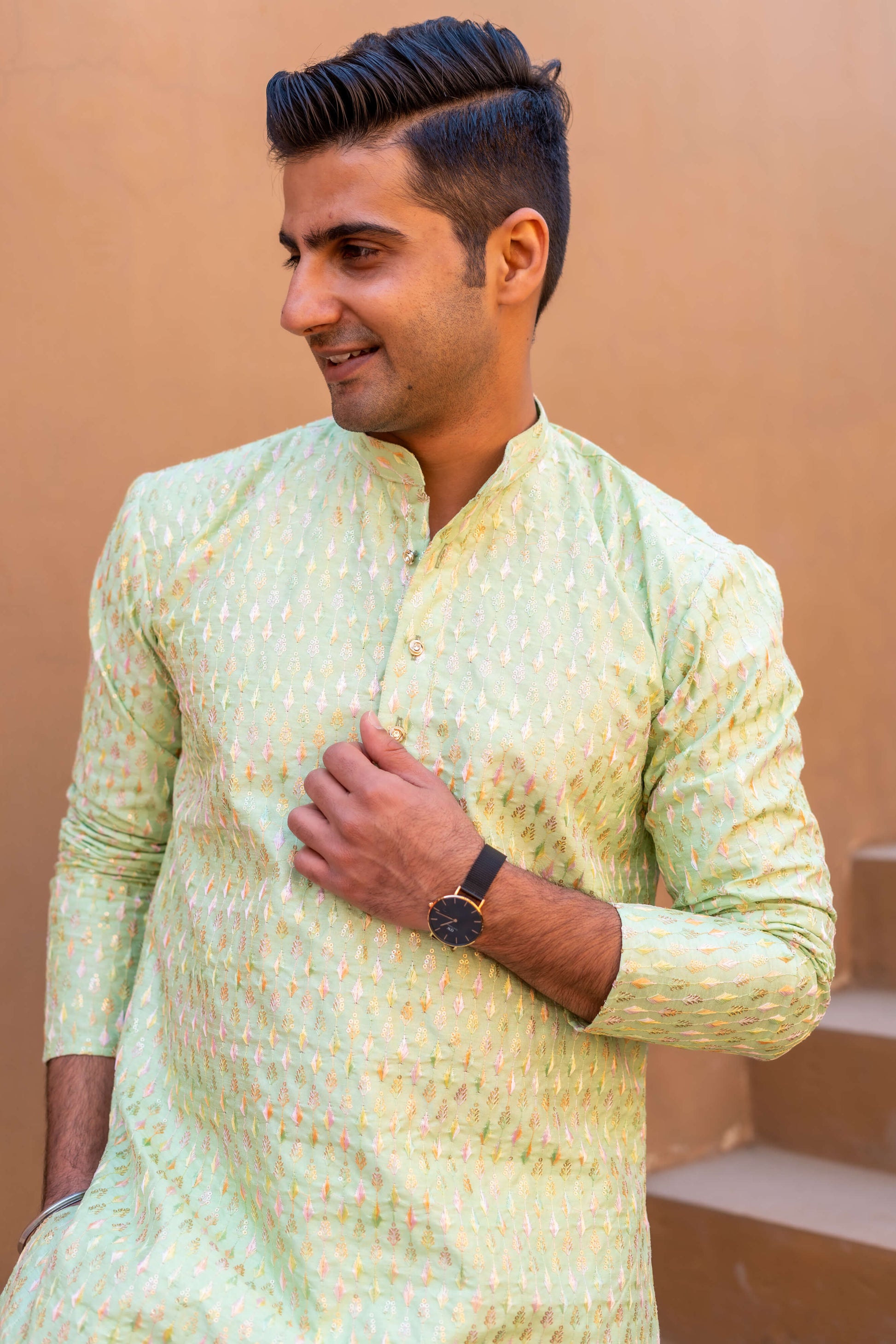 a man wearing pista green color kurta