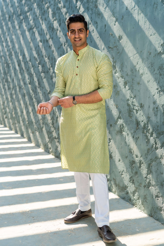 The Golden Zigzag Embroidery Work Long Kurta In Pastel Green Color