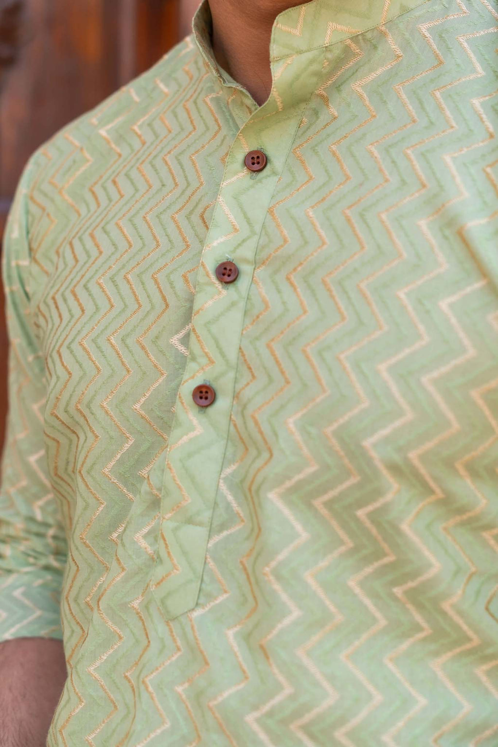 The Golden Zigzag Embroidery Work Long Kurta In Pastel Green Color