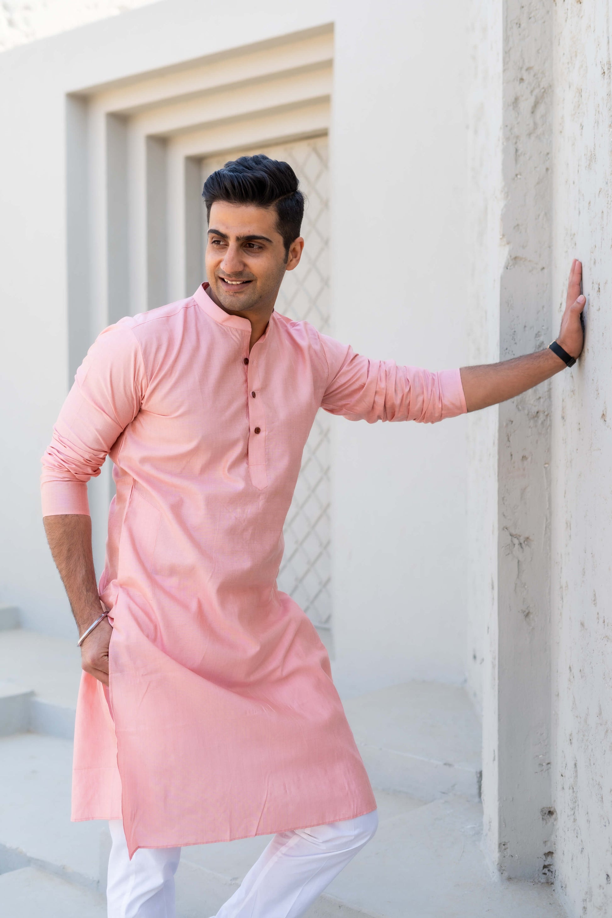 Indian men wearing a pink color long kurta and white pajama
