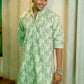 An Indian man wearing green chikan kari long kurta 