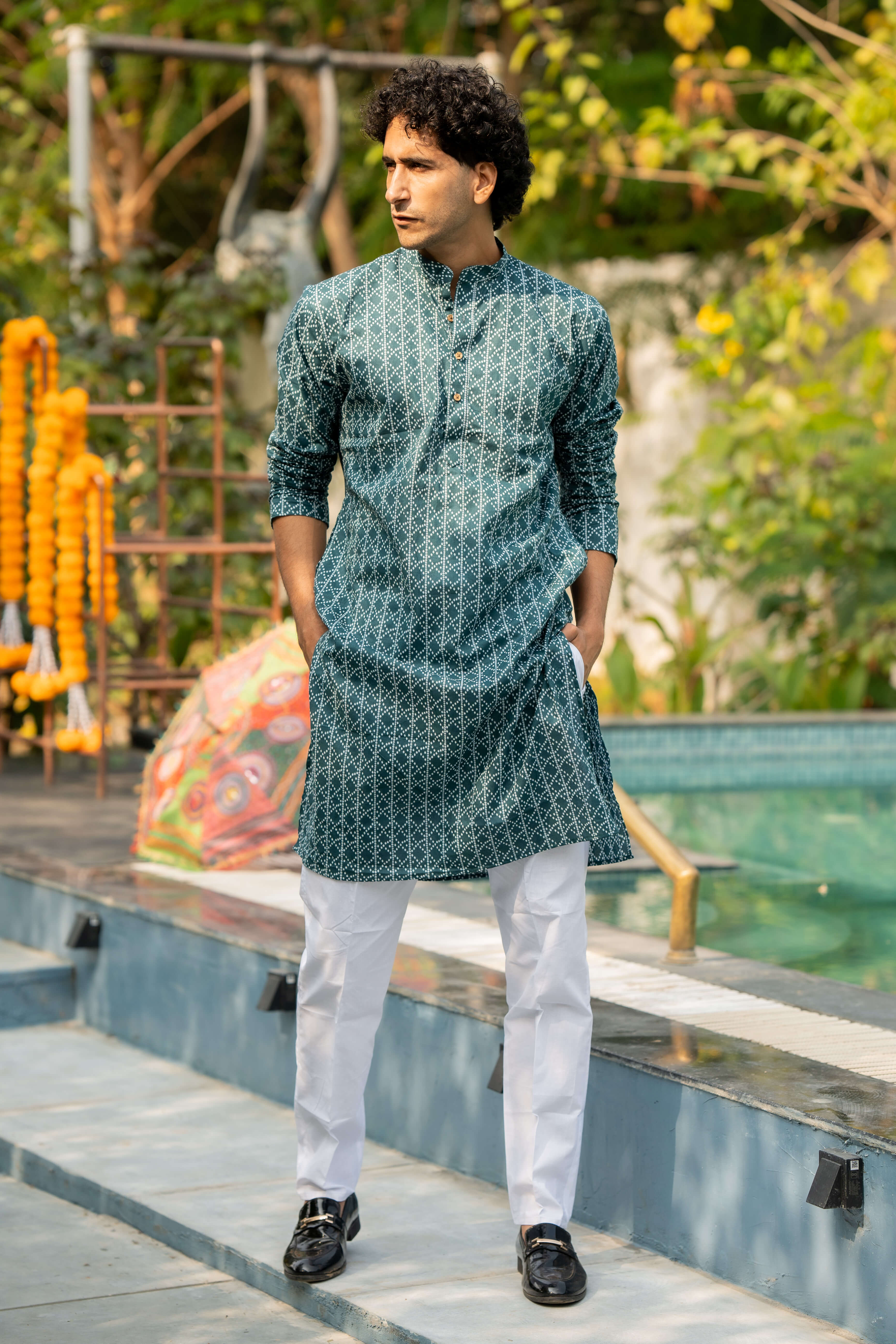 indian man wearing a green long kurta featuring geometric print. 