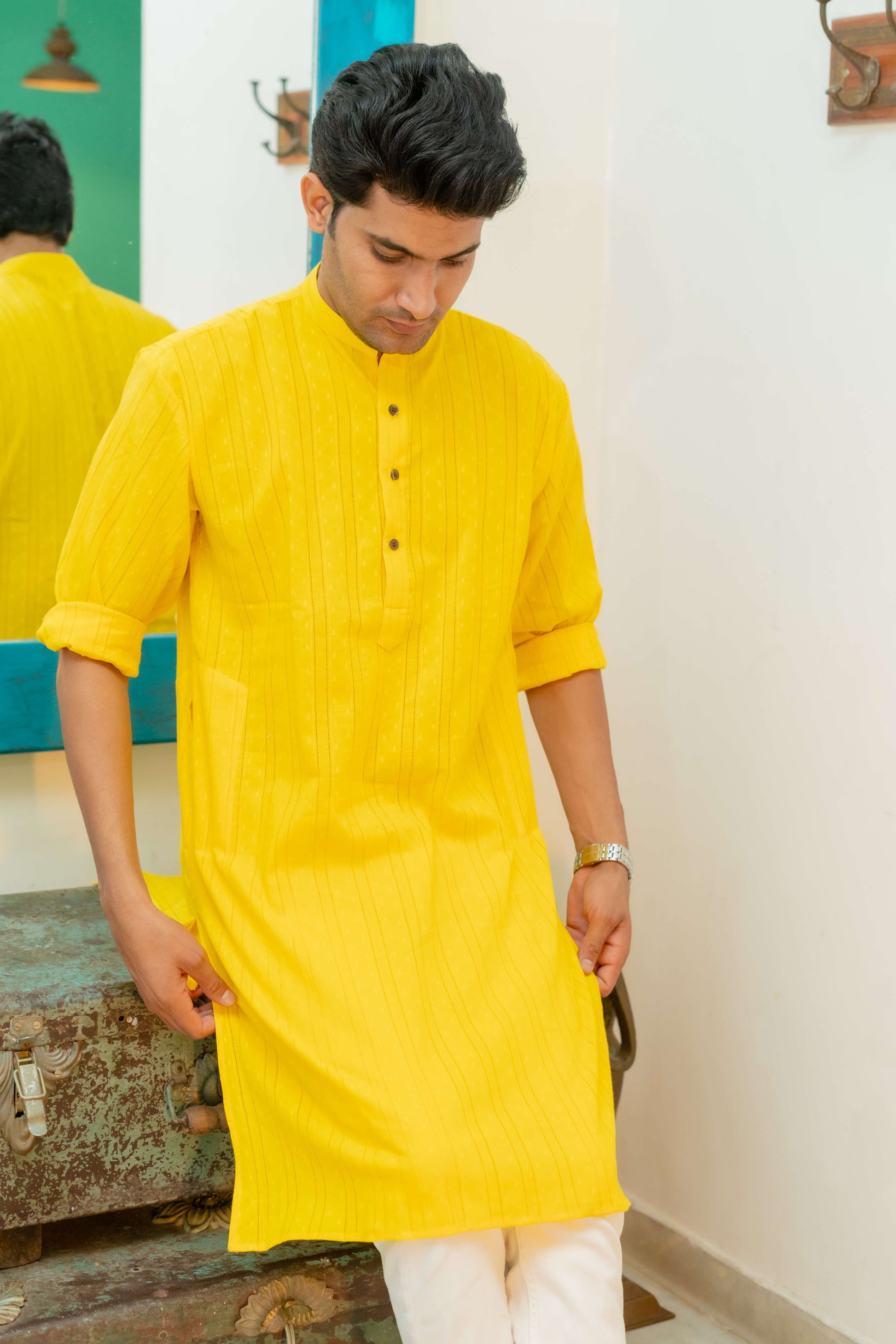 Indian man wearing yellow long kurta