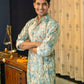 An Indian Man Wearing Off-White Floral Print Long Kurta Giving Showing Side Look of Kurta