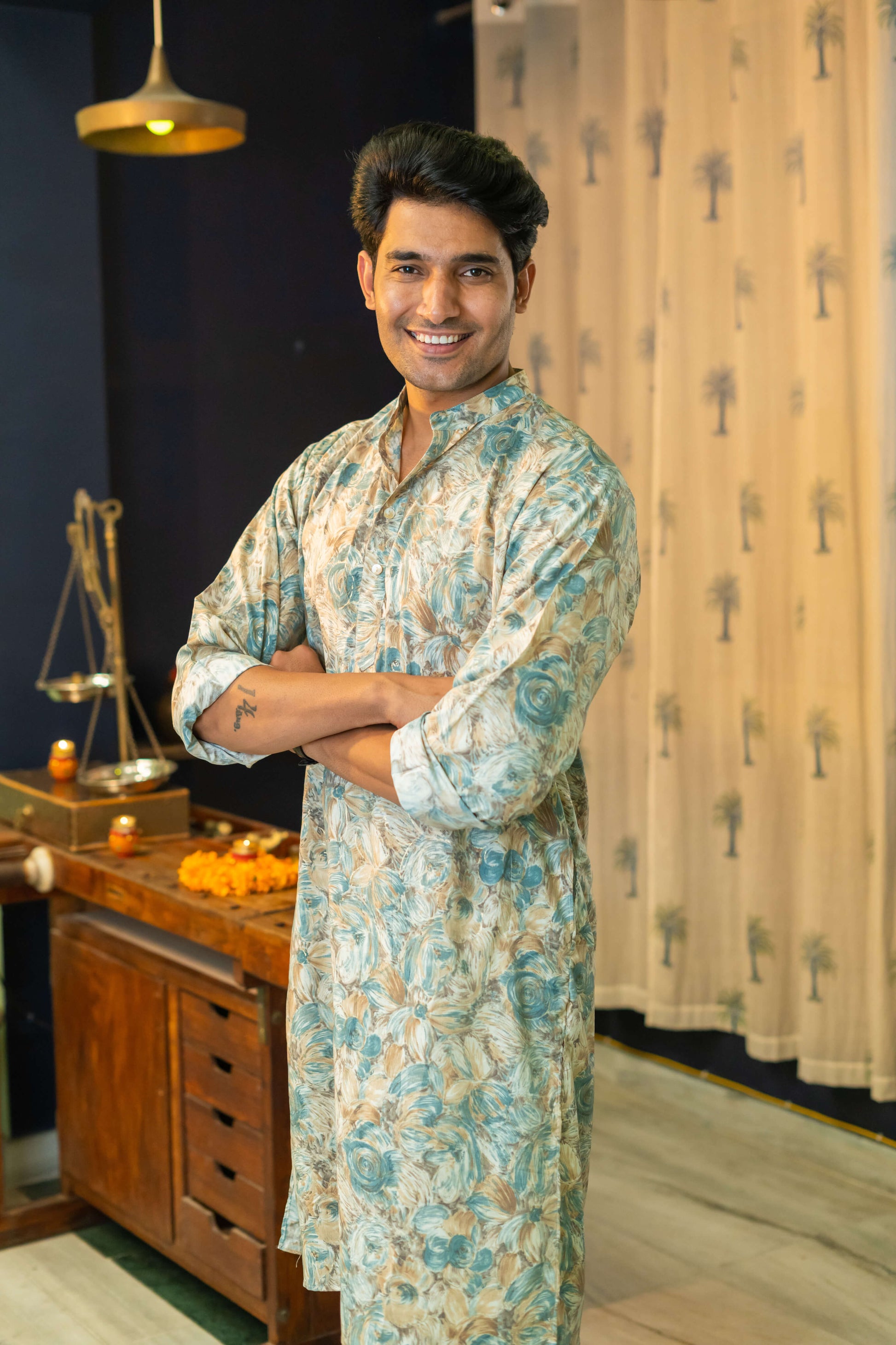 An Indian Man Wearing Off-White Floral Print Long Kurta Giving Showing Side Look of Kurta