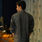 Back View of a Black Long Kurta For Men With a Geometric Print