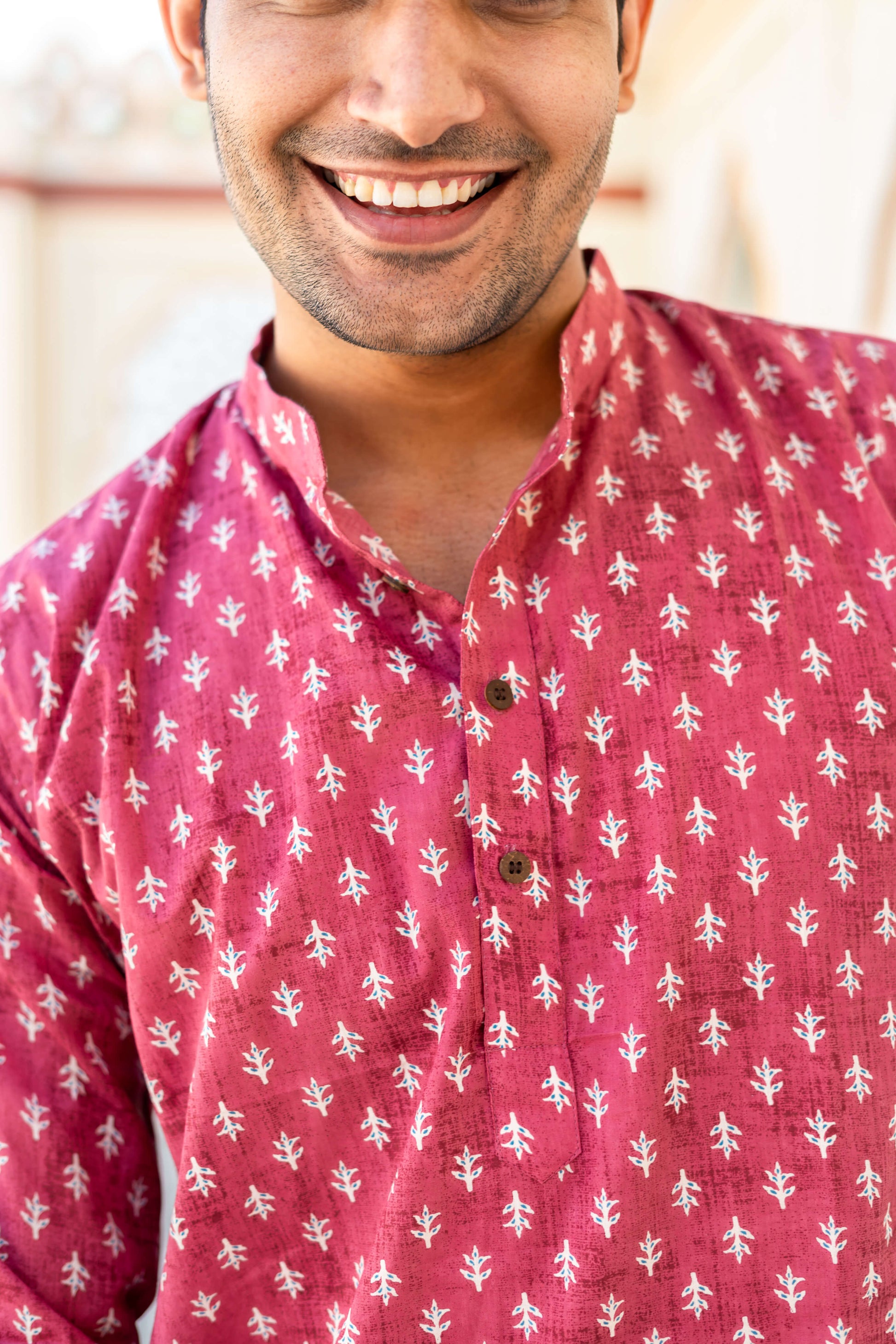 Close-up view of An Indian man wearing pink color short kurta 