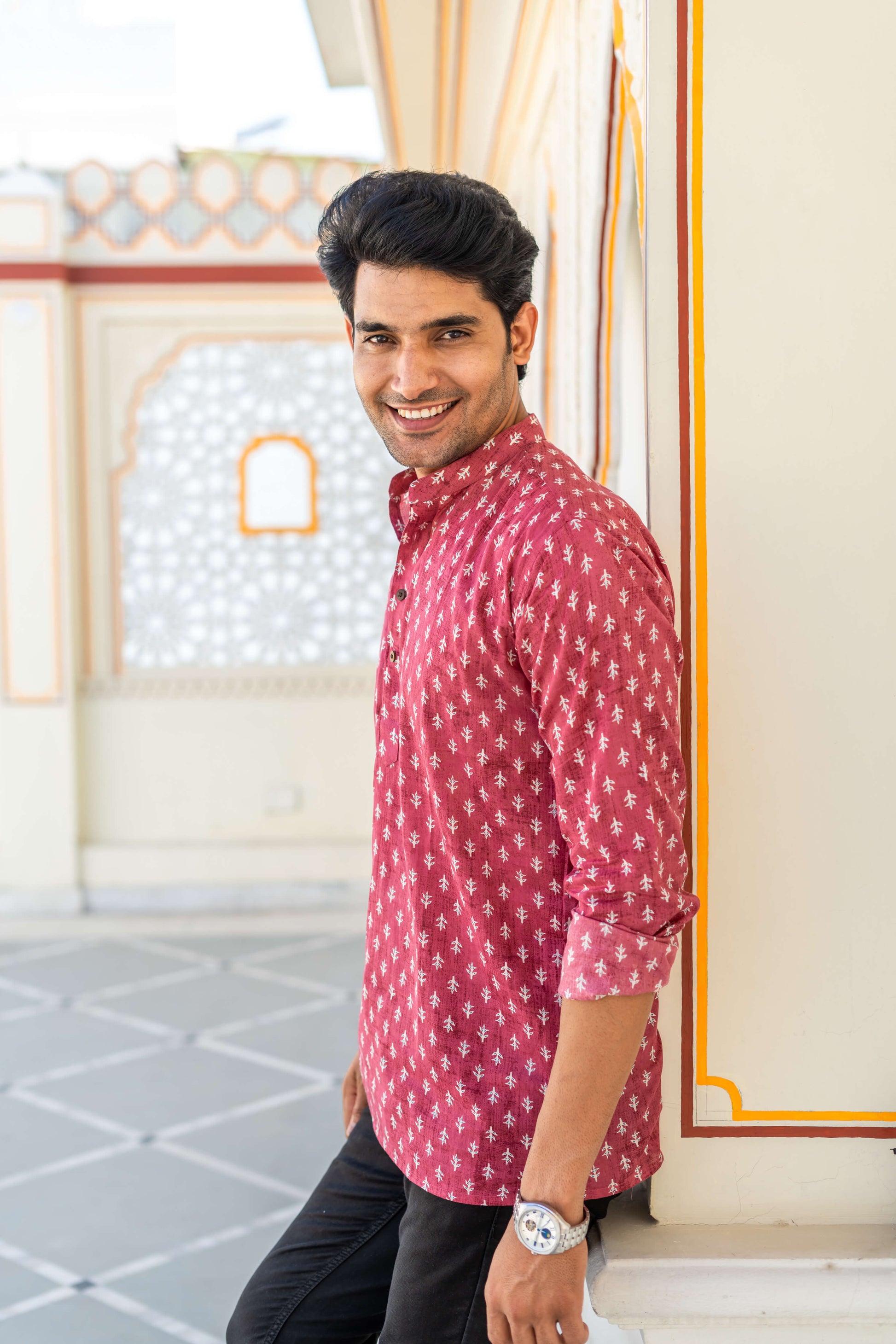 Side view of An Indian man wearing a pink short kurta for men